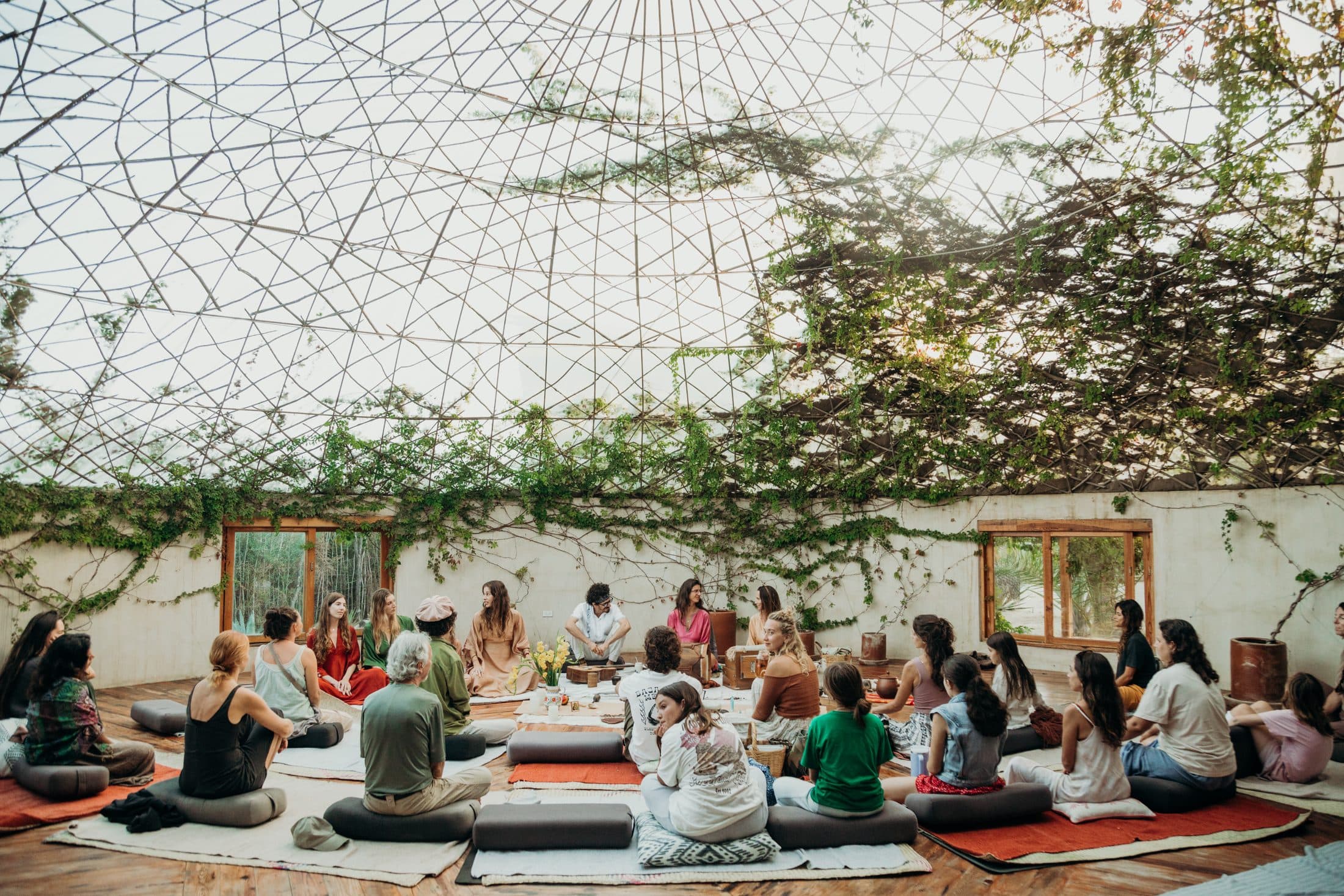 A sangha circle gathered under the vine-covered dome at Casa Damara